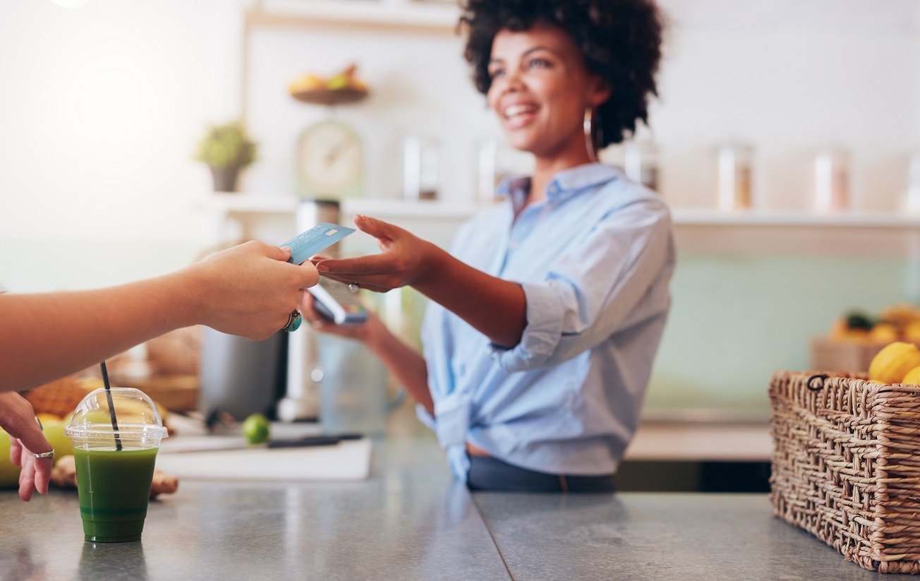 Clerk accepting credit card from customer